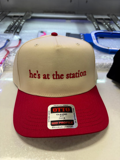 Embroidered "he’s at the station” Hat